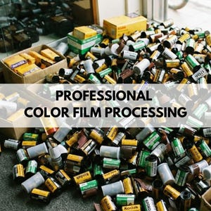 May include: A large pile of assorted 35mm film canisters in various colors including yellow, green, white, and black, with some stored in cardboard boxes. The text PROFESSIONAL COLOR FILM PROCESSING is overlaid in black on a white horizontal bar.
