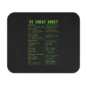 May include: Black rectangular mouse mat with rounded corners. The mat features green text of a "VI CHEAT SHEET" with commands and navigation instructions. The text is in a sans-serif font.