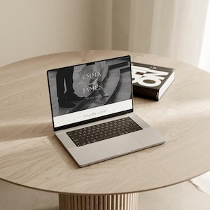 Editorial black and white Canva wedding website template on laptop and desk