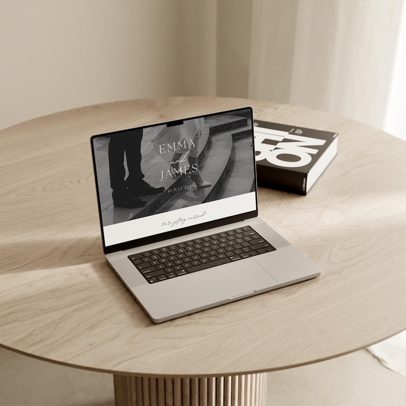 Editorial black and white Canva wedding website template on laptop and desk