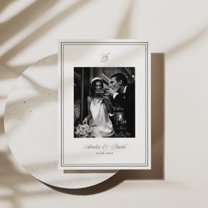 Wedding thank you card with elegant black and white design, minimialist frame, and elegant script font