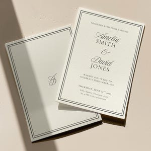 Black and white wedding invitation flat lay showing coordinated stationery set