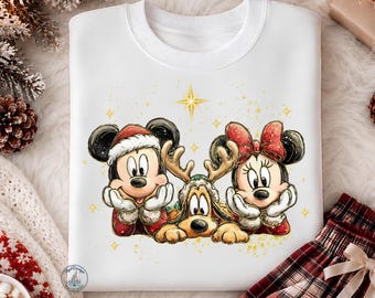 May include: A white crewneck sweatshirt featuring a graphic illustration of Mickey Mouse wearing a Santa hat, Minnie Mouse with a red bow, and Pluto wearing reindeer antlers, all resting their chins on their hands with gold star accents.