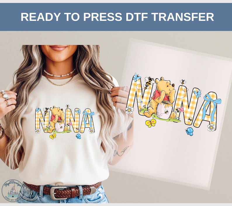 May include: A beige t-shirt with the word "NANA" in a yellow and white checkered pattern, featuring a Winnie the Pooh graphic. The design includes bees, butterflies, and flowers. The text "READY TO PRESS DTF TRANSFER" is at the top.