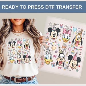 May include: A beige t-shirt featuring a colorful graphic of Mickey Mouse, Minnie Mouse, Donald Duck, Daisy Duck, and Pluto, all wearing party hats. The words "READY TO PRESS DTF TRANSFER" are at the top.