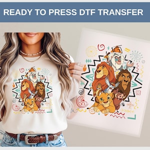 May include: A cream-colored t-shirt and a DTF transfer featuring a colorful illustration of characters from The Lion King. The design includes Simba, Mufasa, Scar, Timon, Pumbaa, and Rafiki, surrounded by geometric shapes and the text "READY TO PRESS DTF TRANSFER".