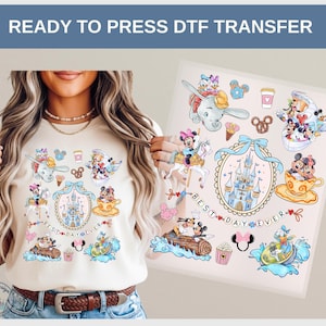 May include: A beige t-shirt featuring a colorful DTF transfer design with various Disney characters, including Mickey and Minnie Mouse, Dumbo, and Donald Duck. The design includes the text "BEST DAY EVER" and other Disney-themed elements.