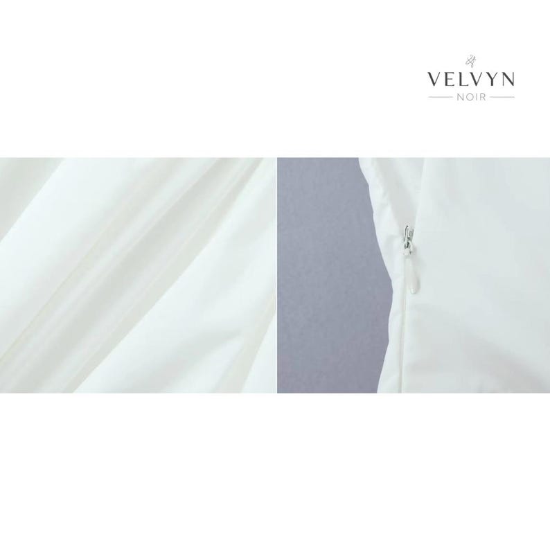 May include: Close-up of a white garment with a zipper detail. The fabric has a subtle sheen and is draped in soft folds. The brand name "VELVYN NOIR" is displayed in elegant typography.