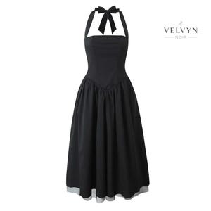 May include: A black halter dress with a bow at the neckline and a flared skirt. The dress has a fitted bodice and a midi length. The brand name "VELVYN NOIR" is printed in white on the right side of the dress.