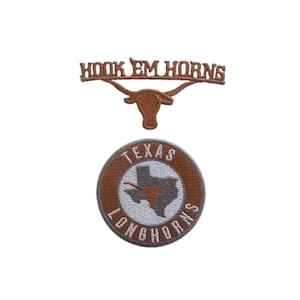May include: Two embroidered patches. The top patch reads "HOOK EM HORNS" above a longhorn silhouette. The bottom patch is circular, with "TEXAS LONGHORNS" around the edge and a Texas outline in the center.