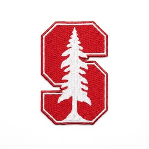 May include: A red embroidered patch in the shape of the letter "S" with a white tree design inside. The patch has a white border and is likely for apparel or accessories.