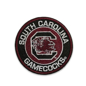 May include: Circular patch with the words "SOUTH CAROLINA GAMECOCKS" in white lettering on a black and maroon background. The center features a maroon "C" with a Gamecock logo.
