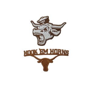 May include: Two embroidered patches featuring the University of Texas Longhorns logo. The top patch depicts a longhorn steer head with an open mouth. The bottom patch reads "HOOK EM HORNS" with a longhorn silhouette.
