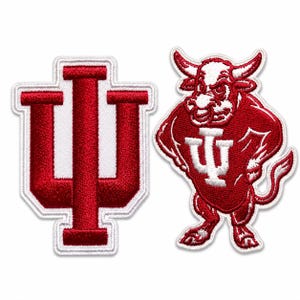 May include: Two embroidered patches featuring the Indiana University logo and mascot. One patch displays the IU logo in red with a white border. The other patch shows a red bull mascot with the IU logo on its chest, also with a white border.