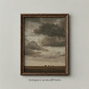 May include: A framed landscape painting featuring a dramatic sky filled with dark, billowing clouds. The artwork depicts a field with a few trees in the distance. The frame is a dark brown color, and the text "AntiqueCuratedPrints" is visible at the bottom.