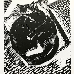 May include: Black and white woodcut print of two cats cuddling. The print is titled "Cuddling Cats" and signed "Sue Haseltine".
