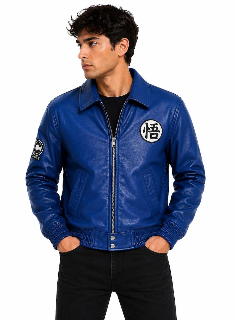 May include: A vibrant blue leather jacket featuring a classic collar, a full-length front zipper, and ribbed cuffs and hem. The chest displays a white circular patch with black Japanese kanji, while the sleeve features a Capsule Corp logo patch.