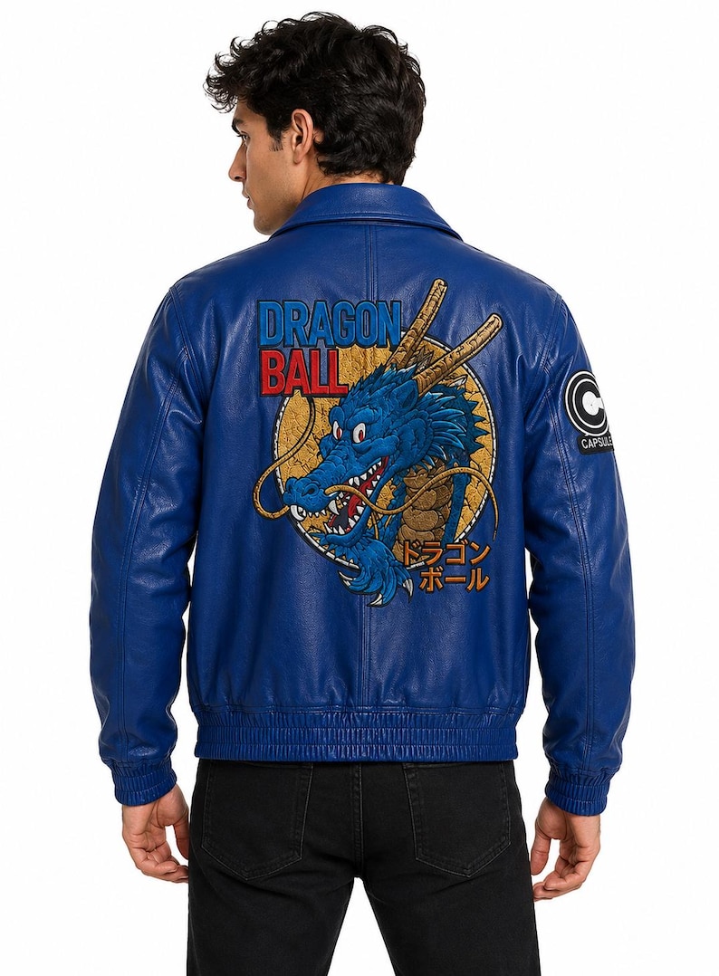 May include: A blue leather jacket featuring a large embroidered graphic on the back of a blue dragon inside a yellow circle, with the text Dragon Ball in blue and red, and Japanese characters. A black and white Capsule Corp logo is on the sleeve.