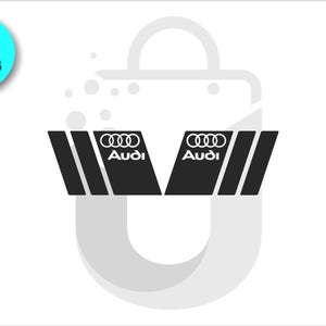 May include: Two black Audi car decals with white Audi logo and text. The decals are angled and have three vertical stripes. A teal circle with the number "2" and the word "PIECES" is in the upper left corner.