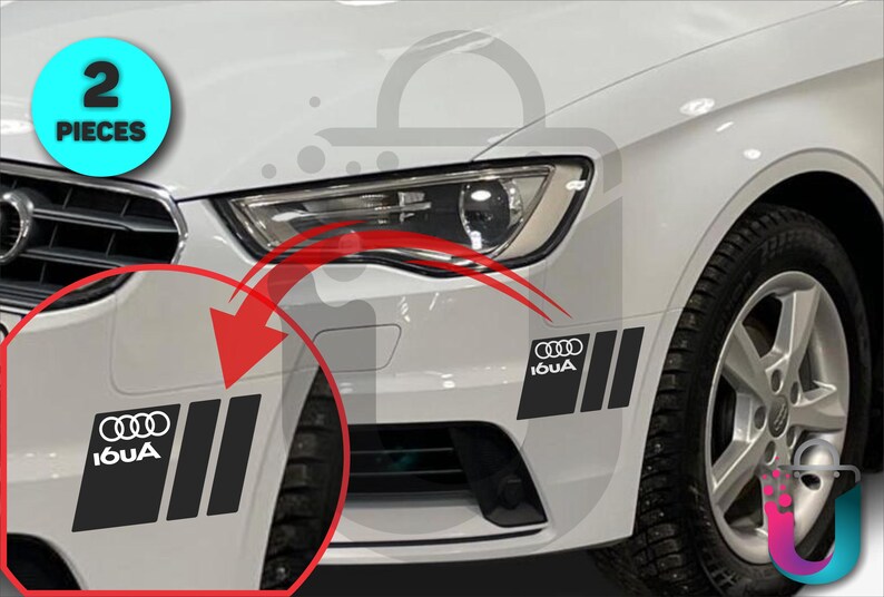 May include: Two black and white car decals with the Audi logo and the text "I6UA" are shown on a white car. The decals are rectangular with three vertical stripes. A blue circle with the text "2 PIECES" is in the upper left corner.