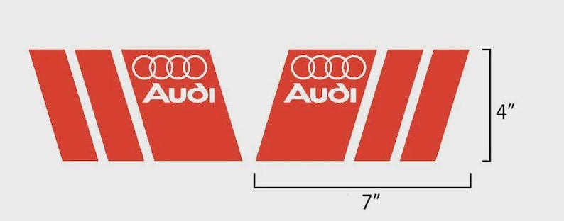 May include: Two red and white Audi decals. Each decal is 7 inches long and 4 inches high. The decals feature the Audi logo and text in white, with three white stripes on a red background.