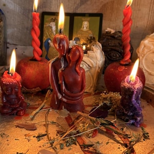 a collection of candles and figurines arranged on a tray, with a warm and inviting atmosphere.