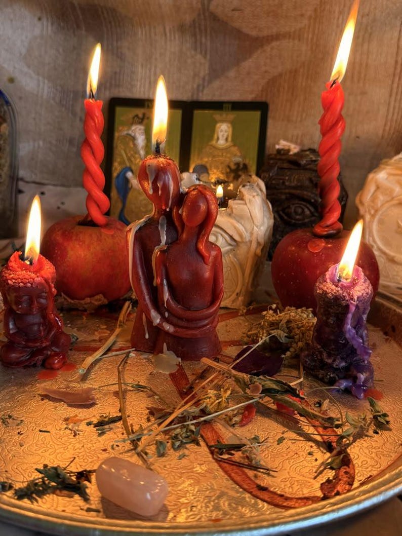a collection of candles and figurines arranged on a tray, with a warm and inviting atmosphere.
