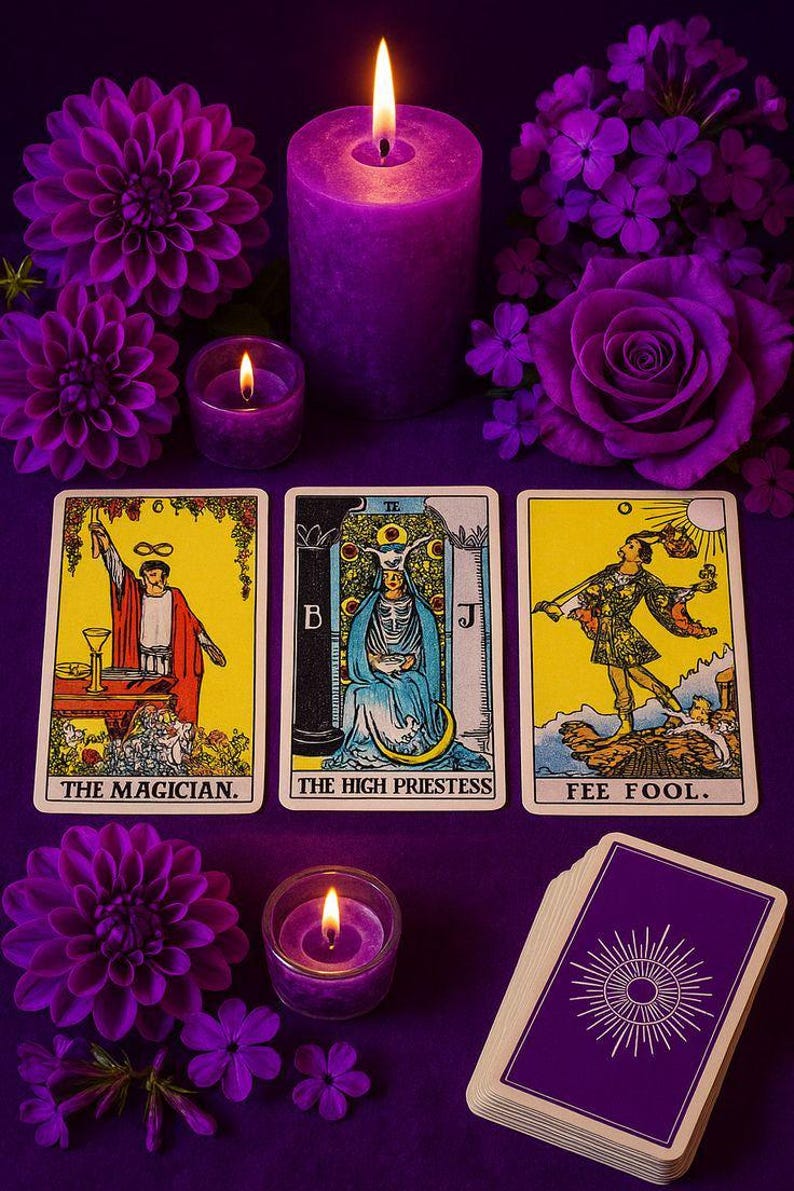 a tarot card spread with three cards, a lit candle, and purple flowers arranged on a purple background.
