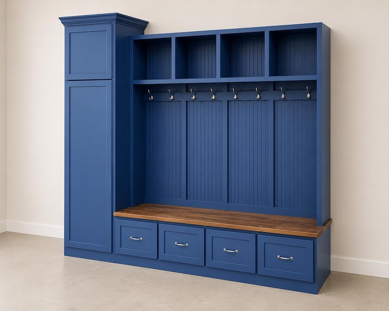 May include: A large, navy blue entryway storage unit with a tall cabinet, open shelves, coat hooks, and four drawers. The unit has a wooden bench and is against a neutral wall.