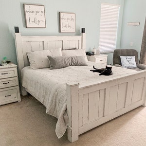 May include: White farmhouse style bed frame with a white and gray striped comforter and a black cat sitting on the bed. The headboard has a distressed white finish and features two signs with the text "where you go I will go" and "where you stay I will stay".