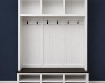May include: A white entryway storage unit with a dark brown bench seat and shoe storage. The unit has open shelves at the top, coat hooks, and a lower section with multiple compartments. The unit is against a dark blue wall.
