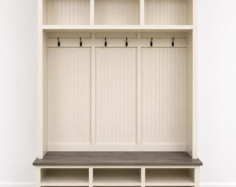 May include: A cream-colored entryway storage unit with a gray bench seat and multiple storage cubbies. The unit features open shelves at the top, coat hooks, and lower shoe storage. The design is a classic, functional piece for home organization.