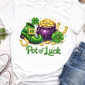 May include: White t-shirt featuring a St. Patrick's Day design. The graphic includes a green leprechaun boot, a pot of gold, a horseshoe, and shamrocks. The text "Pot of Luck" is written in green. A pair of white sneakers and blue jeans are also visible.