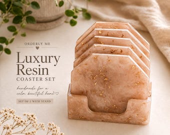 May include: A set of five luxury resin coasters with a matching stand. The coasters are a light peach color with gold flecks, and the stand is the same color. The text on the image reads "Luxury Resin Coaster Set".