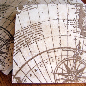 May include: A set of four beige ceramic coasters with a vintage world map design. Each coaster features a compass rose and a detailed map with handwritten text.