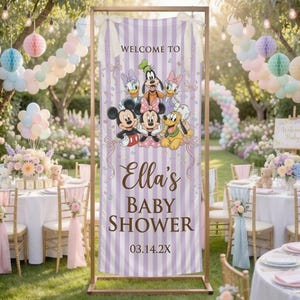 May include: A vertical rectangular banner with a light purple and white striped background, featuring cartoon characters Mickey Mouse, Minnie Mouse, Donald Duck, Daisy Duck, Goofy, and Pluto. The text reads WELCOME TO Ella's BABY SHOWER 03.14.2X.