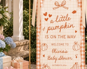May include: A vertical rectangular fabric banner with an orange and white gingham pattern, featuring the text "a little pumpkin IS ON THE WAY" and "WELCOME TO Olivia's Baby Shower OCTOBER 15, 20xx" with pumpkin, heart, and leaf illustrations.