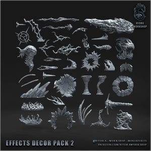 Puede incluir: Una colección de piezas de decoración de efectos en miniatura grises, que incluyen rayos, llamas y formas arremolinadas en forma de nube. El texto "EFFECTS DECOR PACK 2" está en la parte inferior. El logotipo de Hydra Workshop está en la esquina superior derecha.