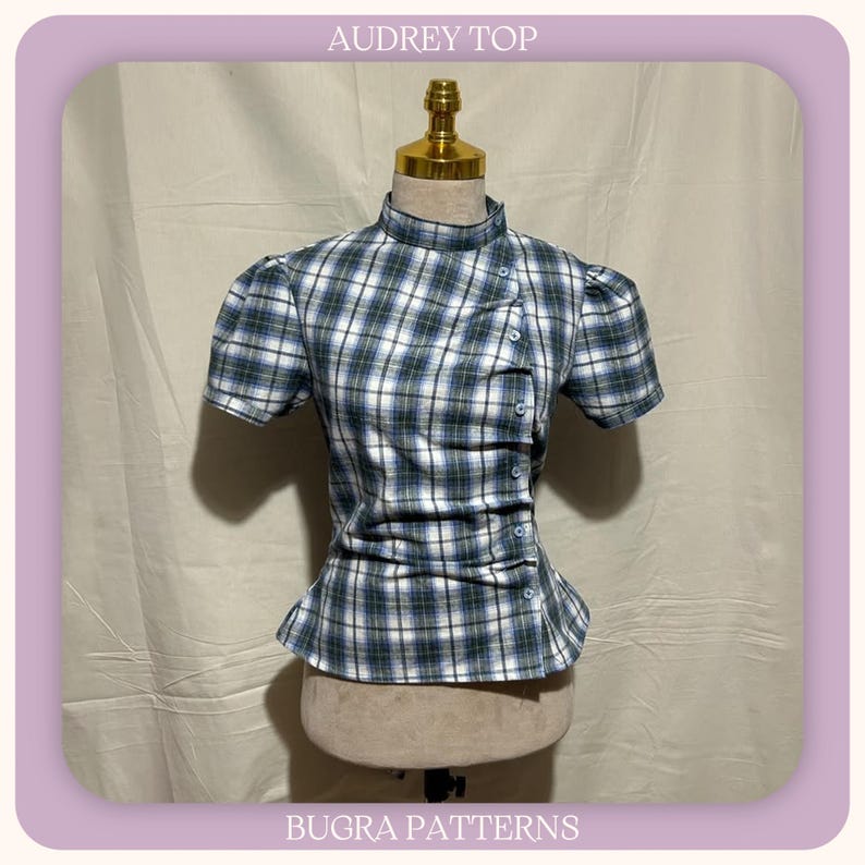 May include: A short-sleeved top with a high neckline and a blue, white, and green plaid pattern. The garment features an asymmetrical button placket running diagonally down the front with gathered fabric details. The text AUDREY TOP and BUGRA PATTERNS is visible.