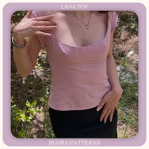 May include: A light pink top with a scoop neckline and cap sleeves. The top is paired with a black skirt. The text "LANA TOP" is at the top of the image, and "BUGRA PATTERNS" is at the bottom.