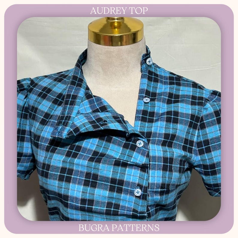 May include: A blue and black plaid top with short sleeves and a button-down front. The garment features a collar and is displayed on a mannequin. The text AUDREY TOP and BUGRA PATTERNS is visible at the top and bottom of the image frame.