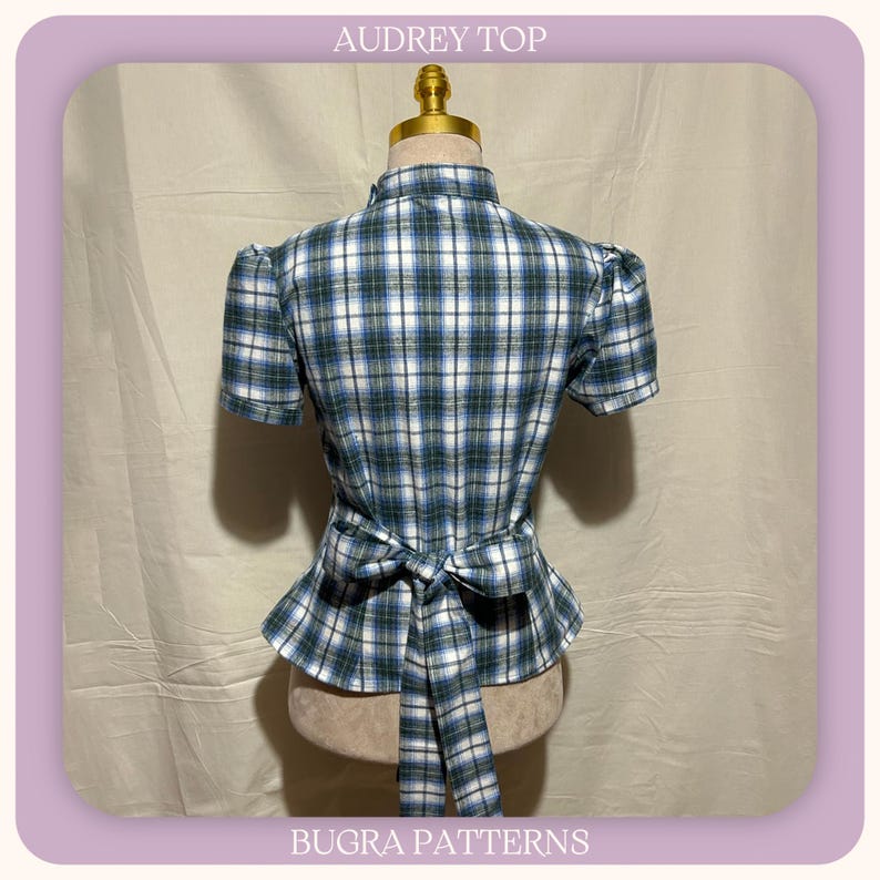 May include: A short-sleeved top with a blue, green, and white plaid pattern, featuring a high collar, puffed sleeves, and a tie-waist detail at the back. The text AUDREY TOP and BUGRA PATTERNS is printed at the top and bottom of the image frame.