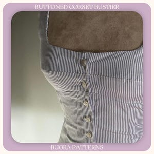 May include: A close-up of a buttoned corset bustier with vertical grey and white stripes. The bustier has a square neckline and is fastened with several buttons down the front. The text "BUTTONED CORSET BUSTIER" and "BUGRA PATTERNS" are visible.