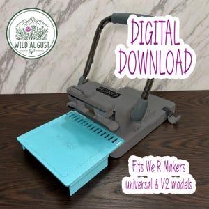 May include: A gray binding machine with a teal platform attachment featuring the text Wild August. The image includes text stating Digital Download and Fits We R Makers universal & V2 models. The machine has a metal handle and base.