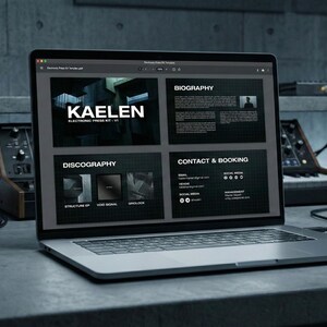 May include: A laptop displaying a website for "KAELEN," an electronic music artist. The website features sections for biography, discography, and contact information. The laptop is on a gray surface, with music equipment in the background.