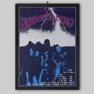 May include: A white ceramic mug with a black handle and the text "But First, Coffee" in a black, handwritten-style font. The mug is on a white surface.