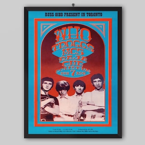 May include: A white ceramic mug with a black handle and the text "But First, Coffee" in a bold, black font. The mug is set against a blurred background, suggesting a cozy setting.