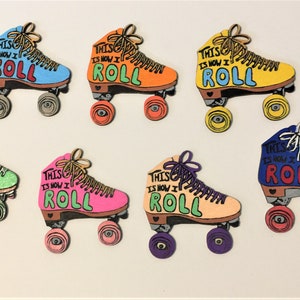 May include: Set of ten colorful roller skate pins with the text "This is how I roll" on each pin. The pins are painted in various colors, including blue, green, yellow, pink, and orange.
