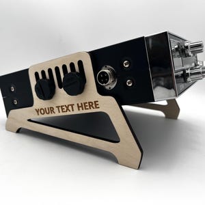 May include: A set of three ceramic mugs with a speckled, matte finish. The mugs are in shades of cream, light gray, and dark gray. Each mug has a simple, minimalist design, perfect for coffee or tea.