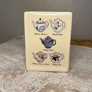 May include: A set of three ceramic mugs with a speckled, matte finish. The mugs are in shades of cream, light gray, and dark gray. Each mug has a simple, minimalist design, perfect for coffee or tea.